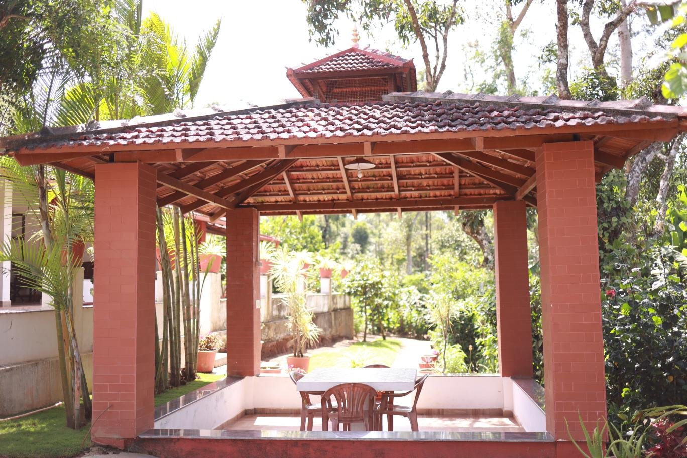 Outdoor gazebo and seating at Ananda Vana Coorg Estate Stay